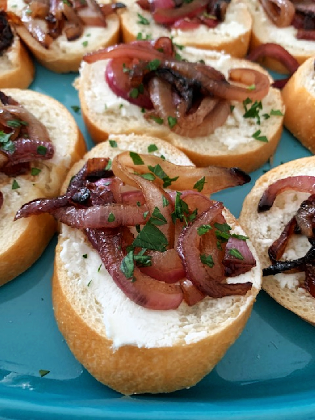 Caramelized onion and cheese canape on a serving platter.