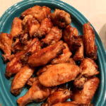 Overhead photo of chicken wings on a blue platter.