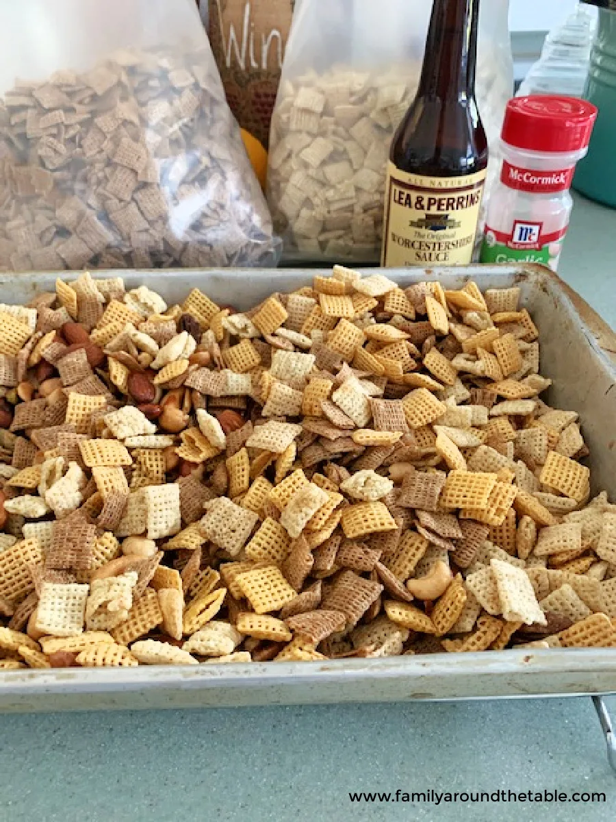 The ingredients for Chex mix in a silver pan.