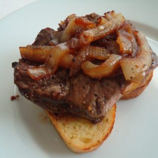 Open-faced steak and onions on garlic toast