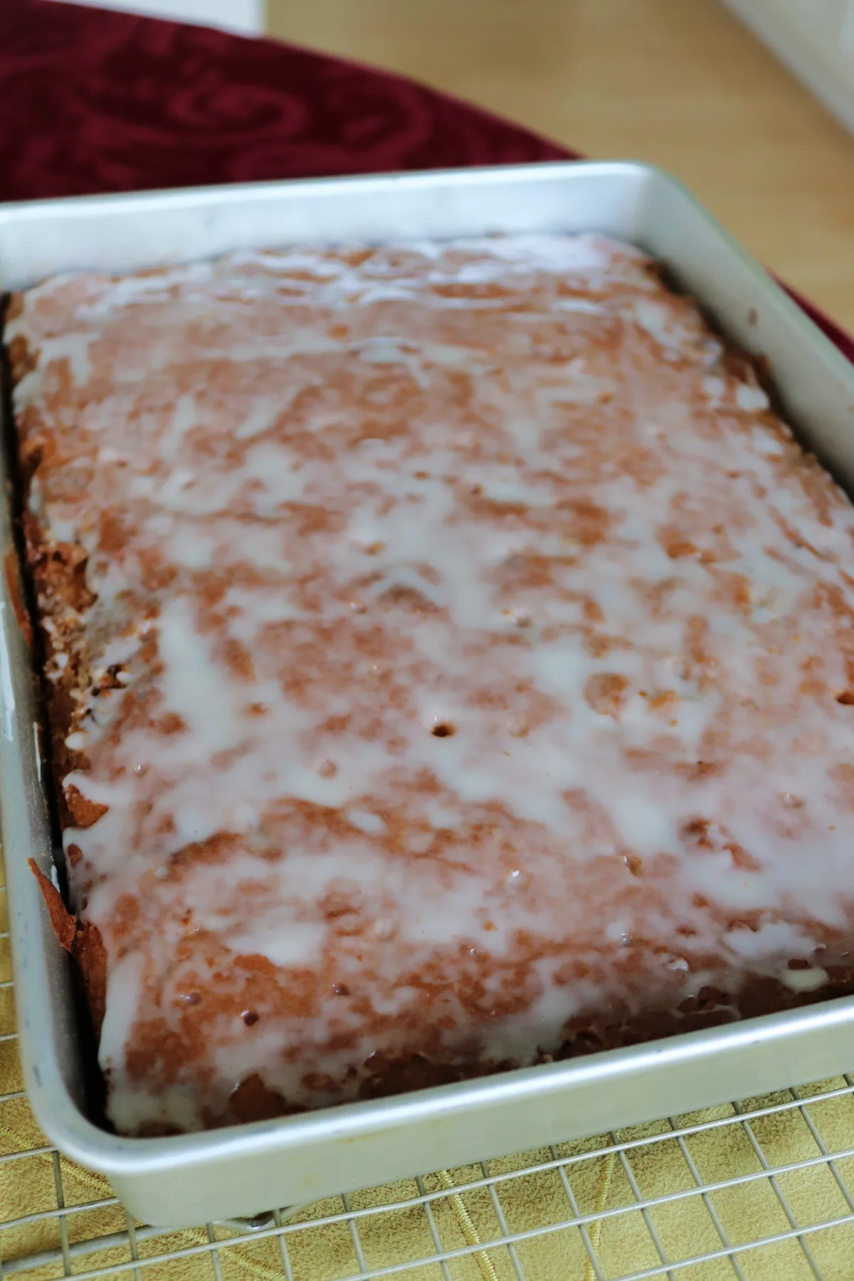 Vanilla glazed honey bun cake in a 9 by 13 baking pan.