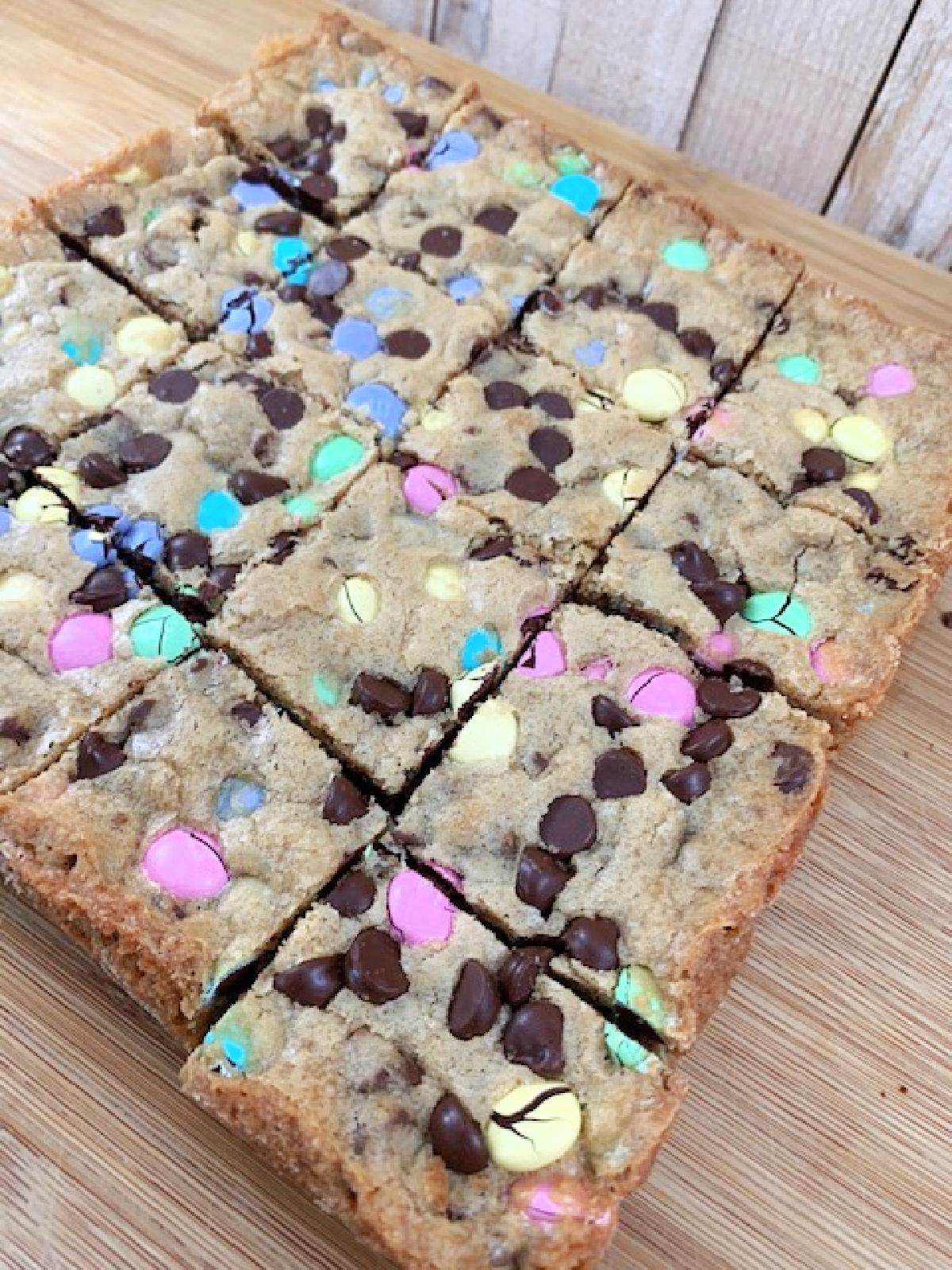 Easter M&M's Chocolate Chip Cookie Bars on a cutting board.