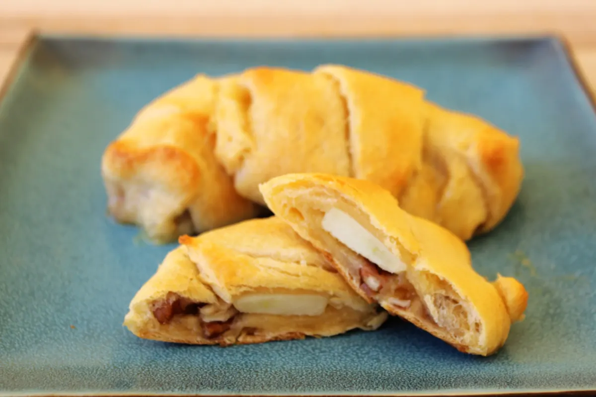 A close up of Apple Brie Roll Ups on a blue plate.
