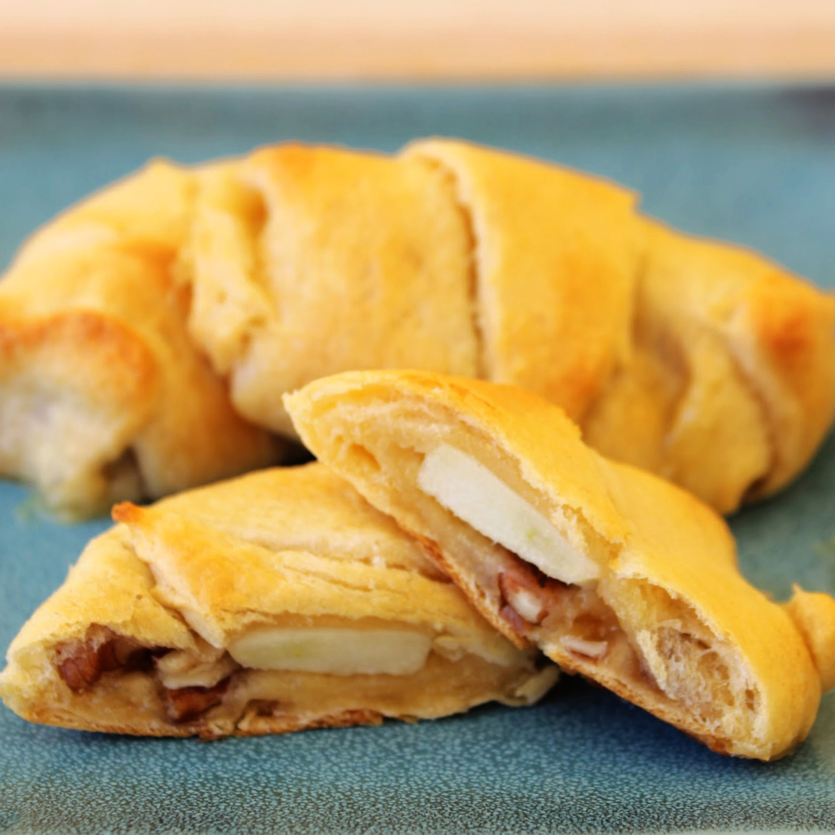 Close up of Apple Brie Roll Ups on a blue plate.