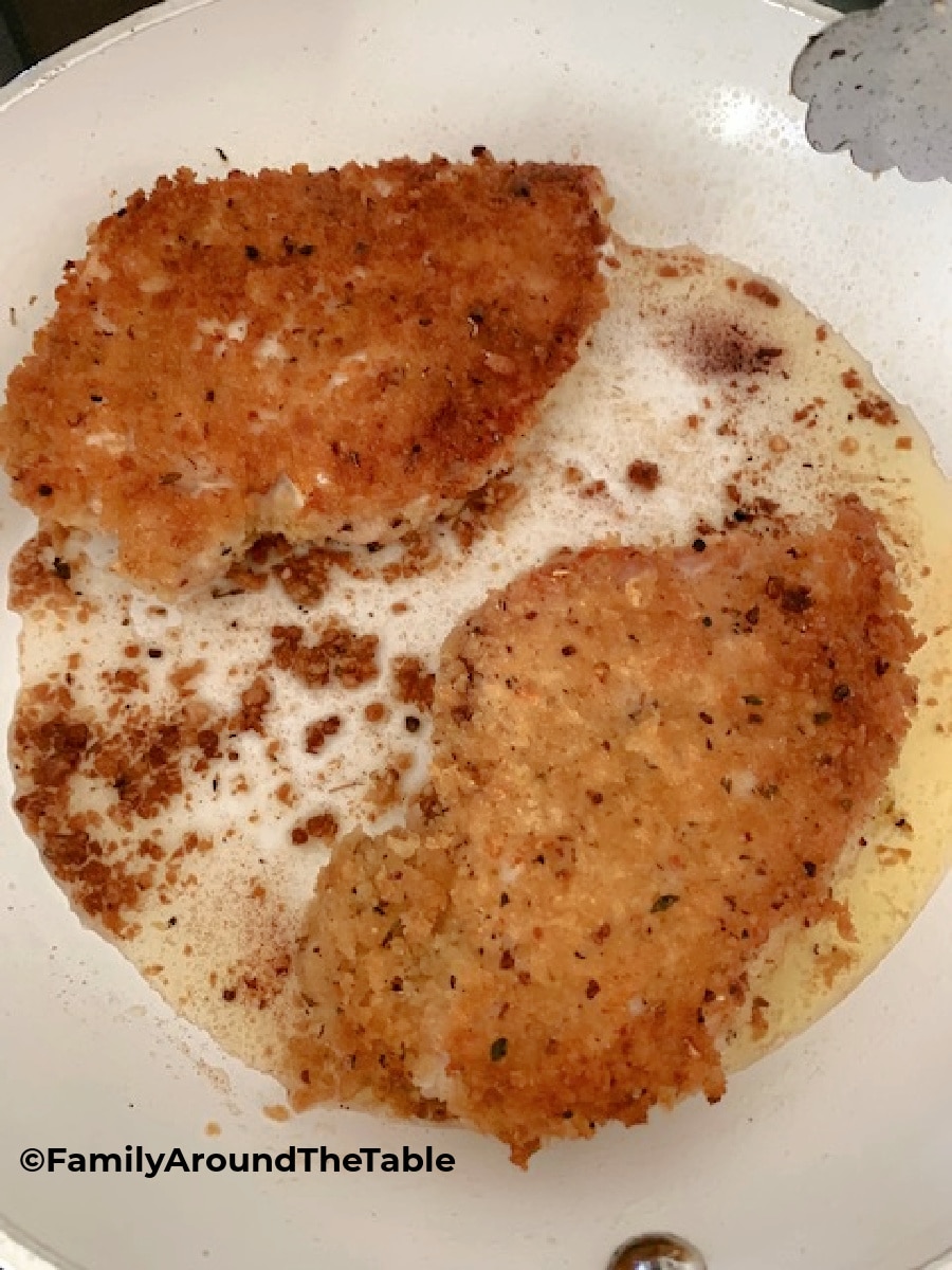 Panko crusted chicken in a skillet.