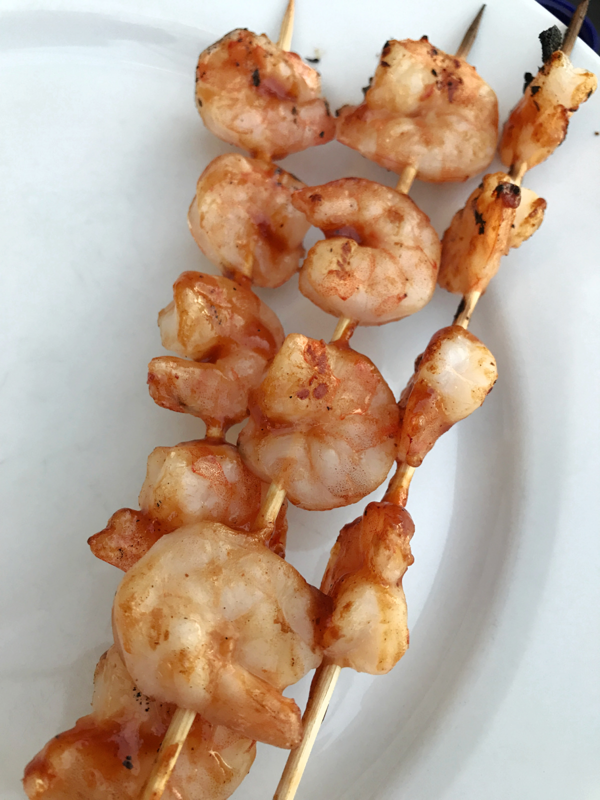 Garlic Butter Shrimp Skewers on a white plate.
