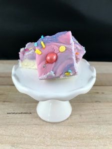 Pieces of pastel fudge on a white stand.