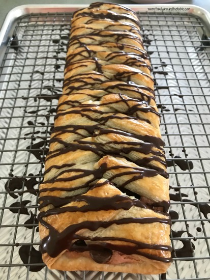 The golden puff pastry peeks through the chocolate glaze.