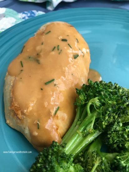 Chicken and broccoli with chive sauce on a blue plate