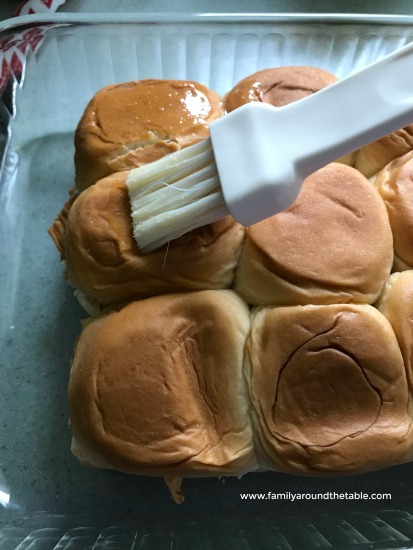 Brushing melted butter over the top makes the buns a bit crispy.