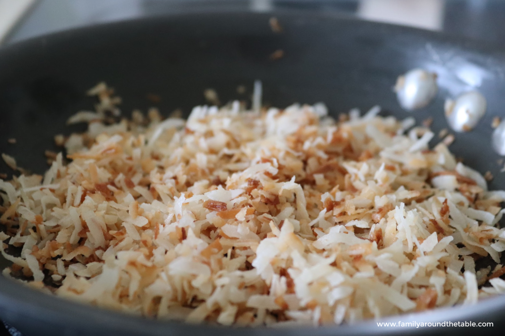 Toasted coconut in a skillet.