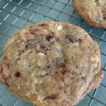 Raspberry white chocolate cookie on cooling rack.