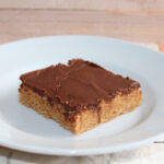 A slice of lunch lady peanut butter bars on a white plate.