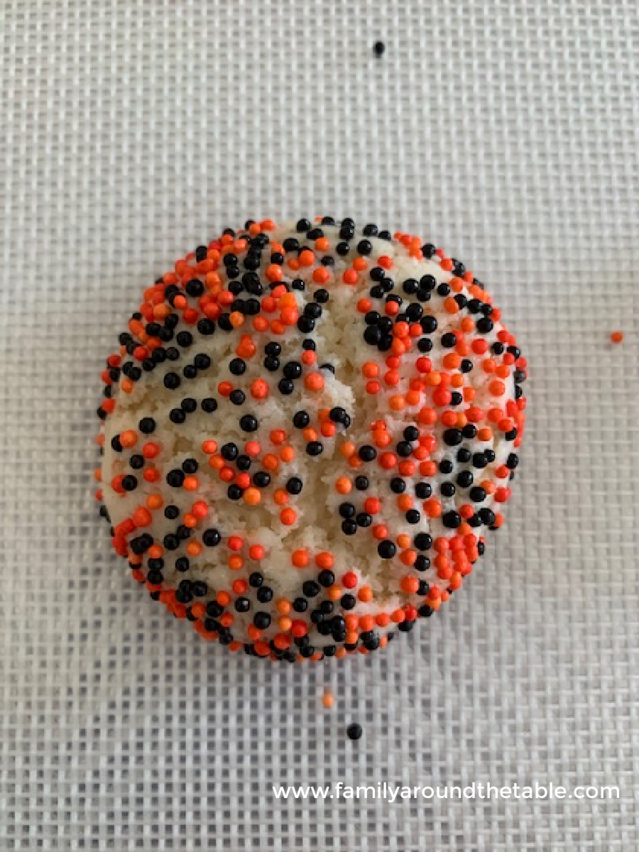 One easy halloween cake mix sprinkle cookie on a baking sheet.