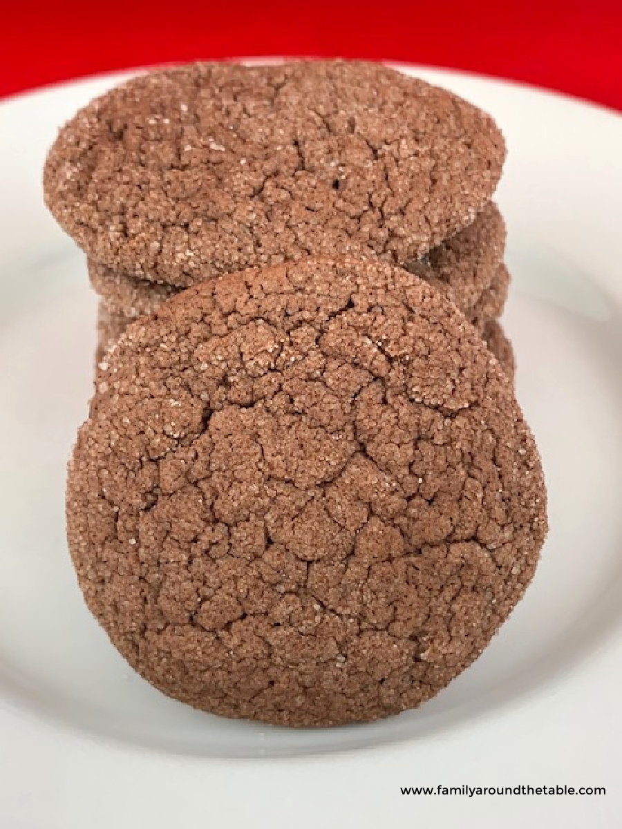 Chocolate cake mix snickerdoodles stacked on a white plate.