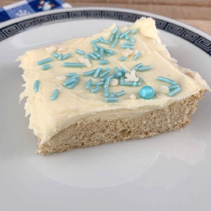 Frosted eggnog cookie bar on a plate.