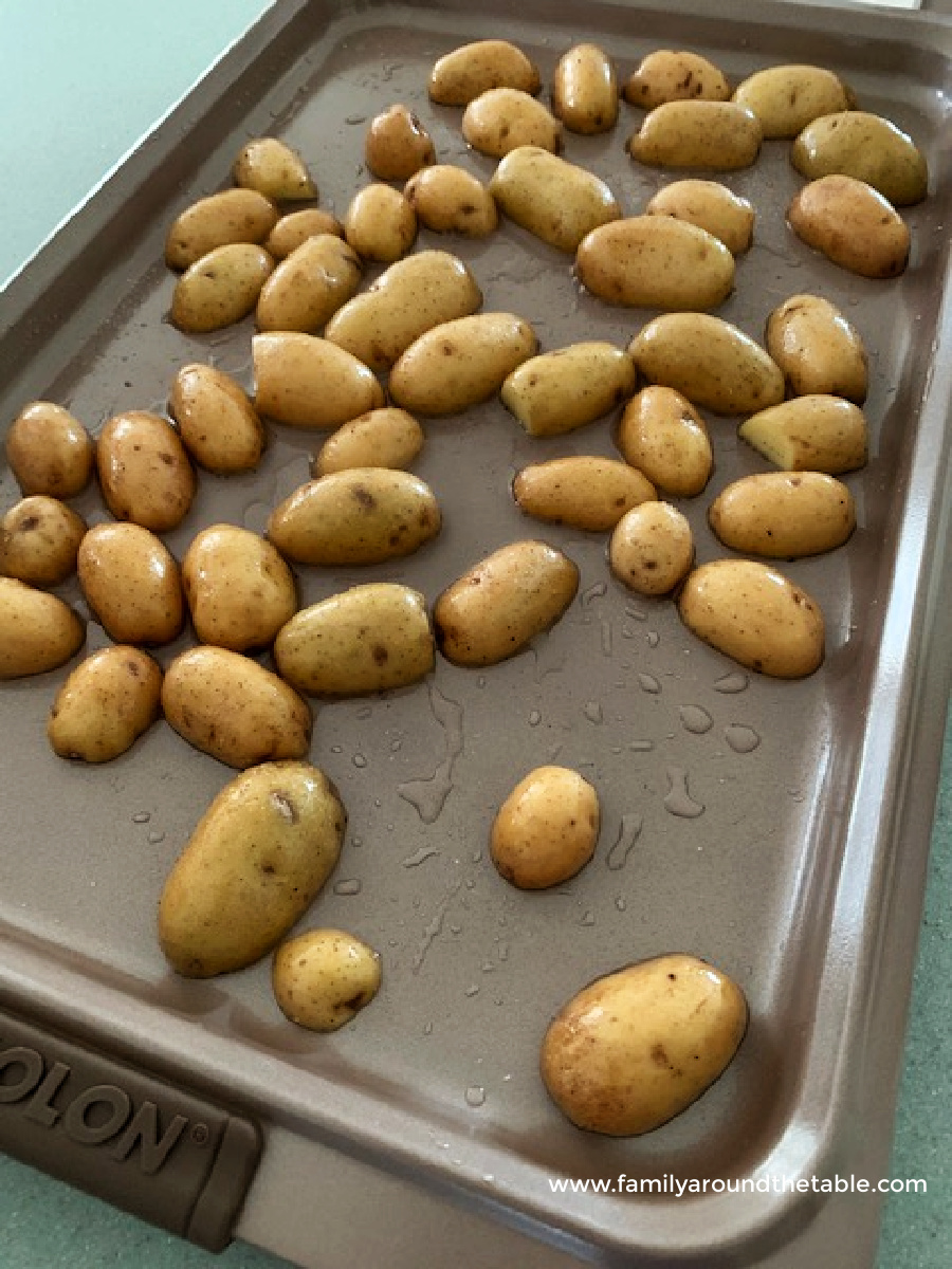 Potatoes on a sheet pan ready for the oven.