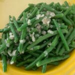 Overhead photo of string beans with shallots.
