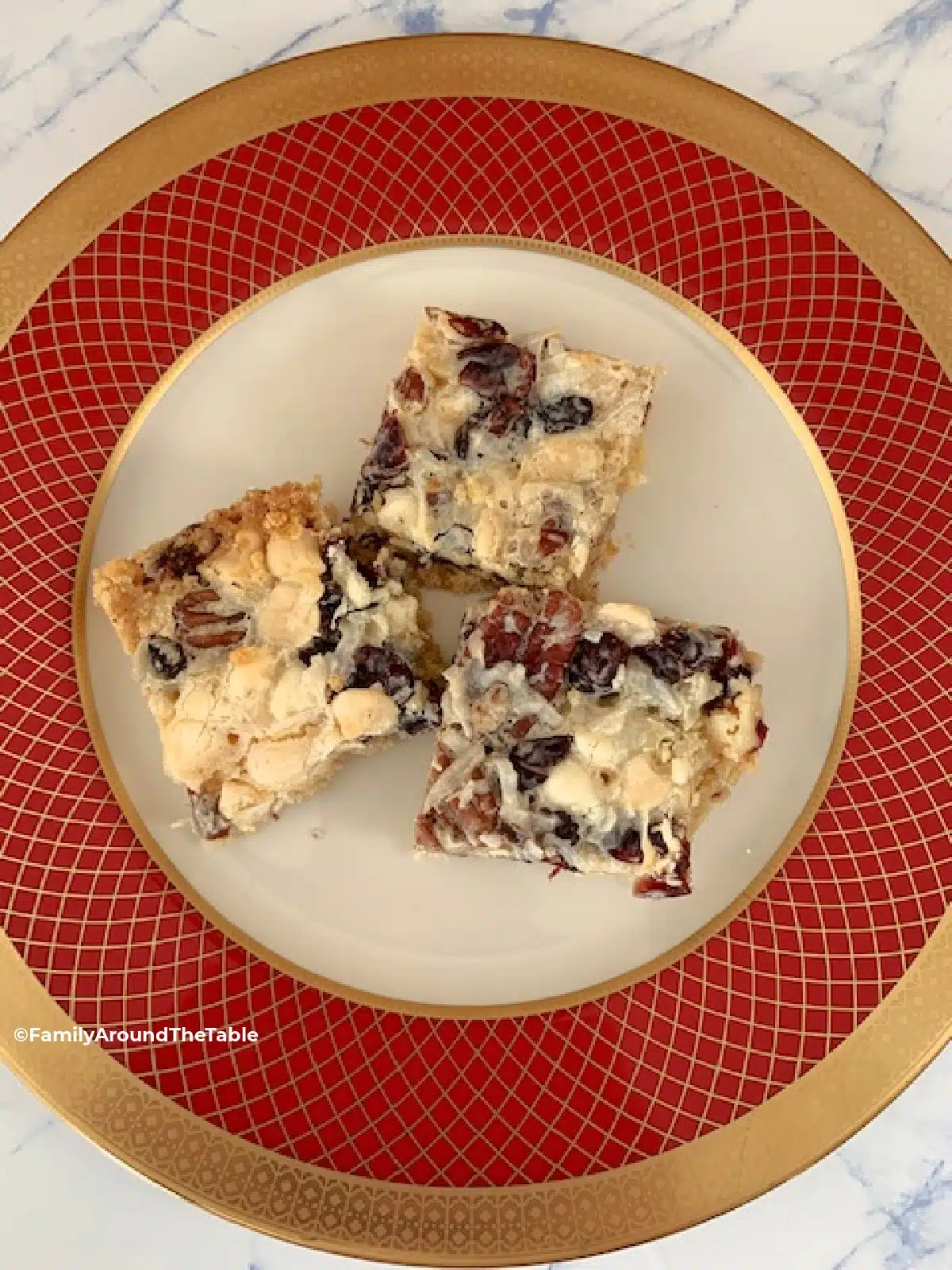 Overhead photo of white chocolate cranberry coconut bars on a red and white plate.