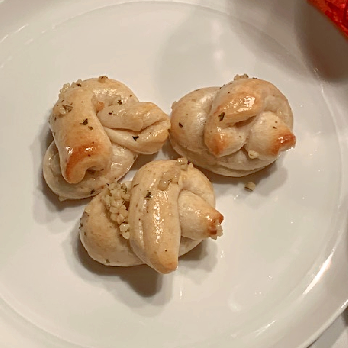 Three garlic knots on a plate.