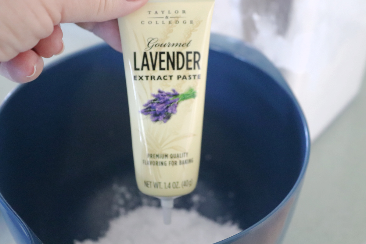 Lavender paste over a bowl with powdered sugar in it.