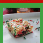 Christmas bars with sprinkles on a white platte. A Pinterest image.