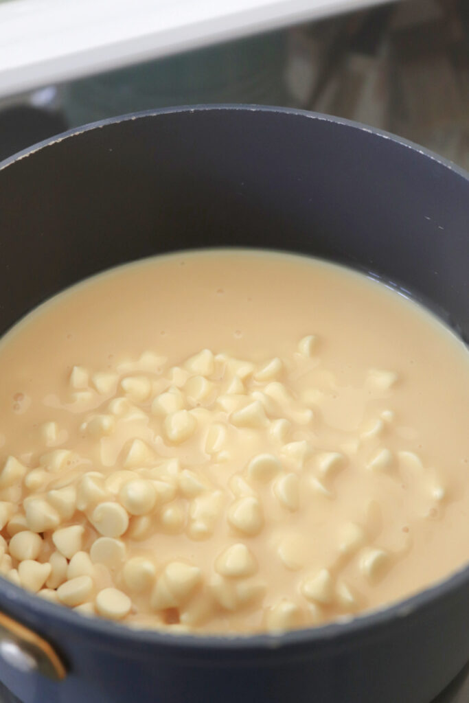 White chocolate chips and sweetened condensed milk in a saucepan.