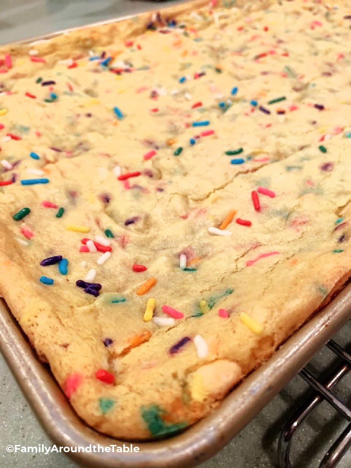 Sprinkle cookie bars in a pan.