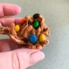 A close up of a haystack candy with multi-color M&Ms.