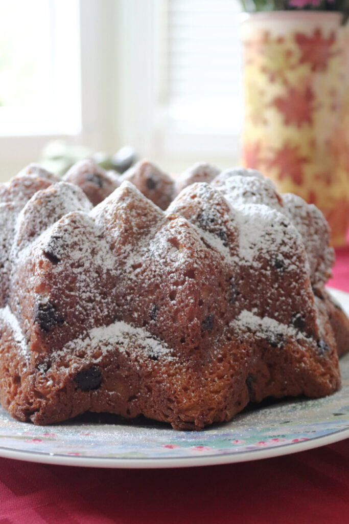 Side view of a Mounds Cake dusted with powdered sugar.
