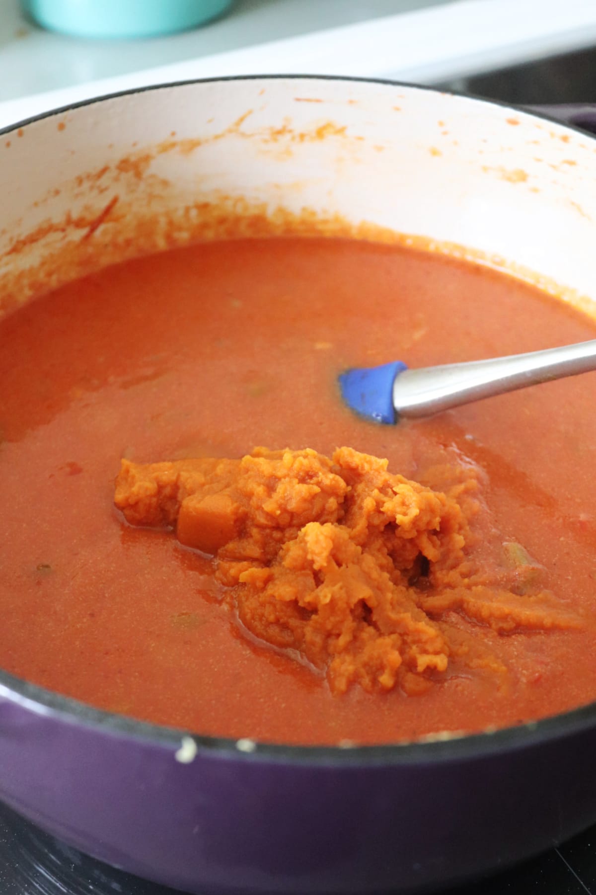 Bisque in a pot with a spatula in it.