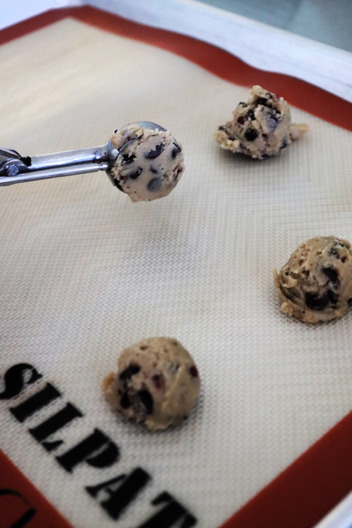 Chocolate Chip Dried Cranberry Cookie dough on a baking sheet.