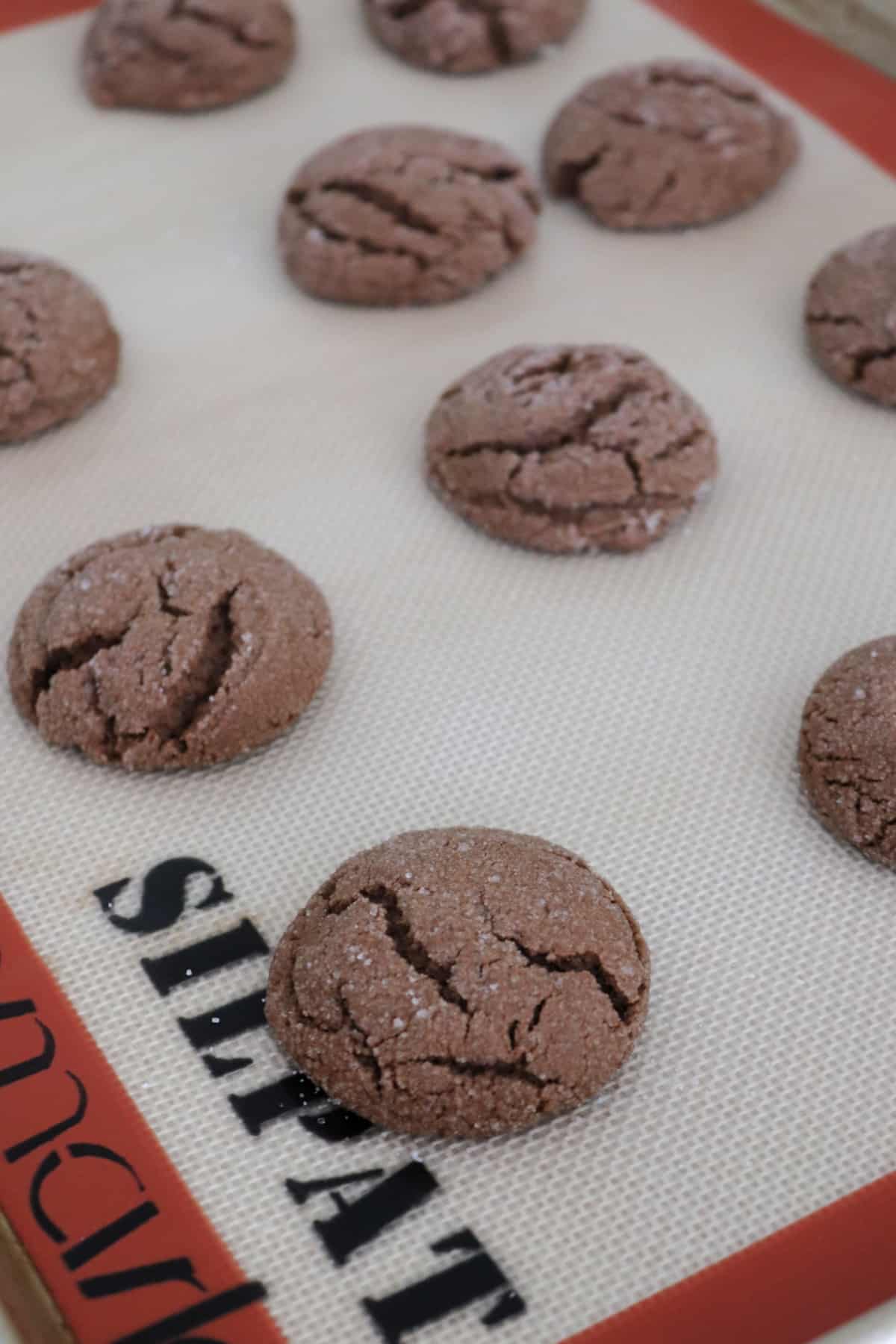 Chocolate Ginger Crinkle cookies on a baking sheet.