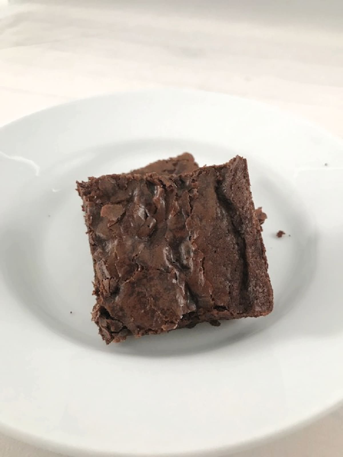 Double chocolate brownies on a white plate.