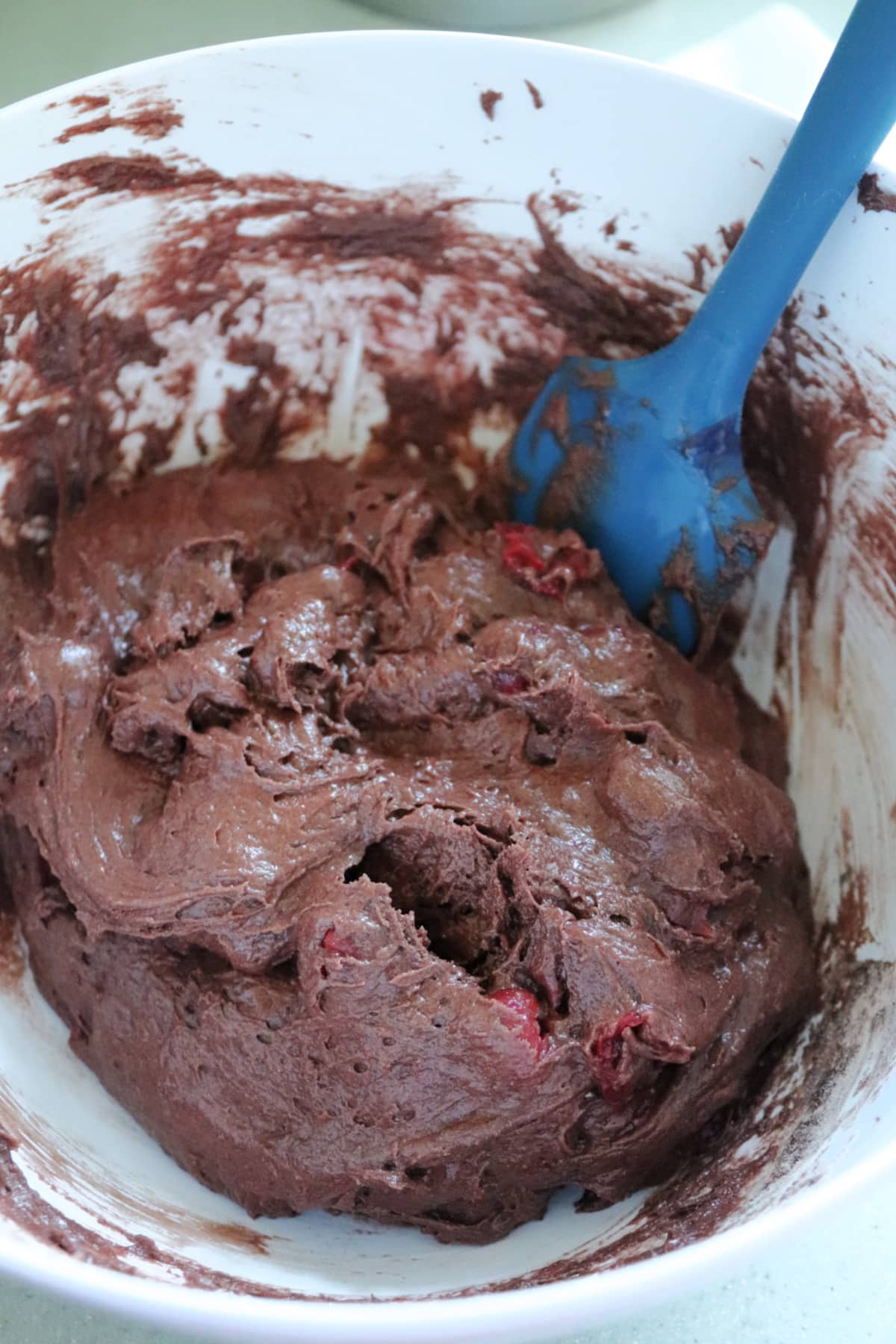 Cherry Chocolate Bars mix in a bowl with a blue spatula.