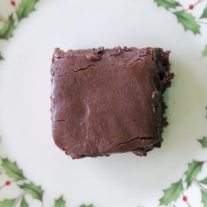 Overhead view of chocolate cherry bars on a Christmas plate.