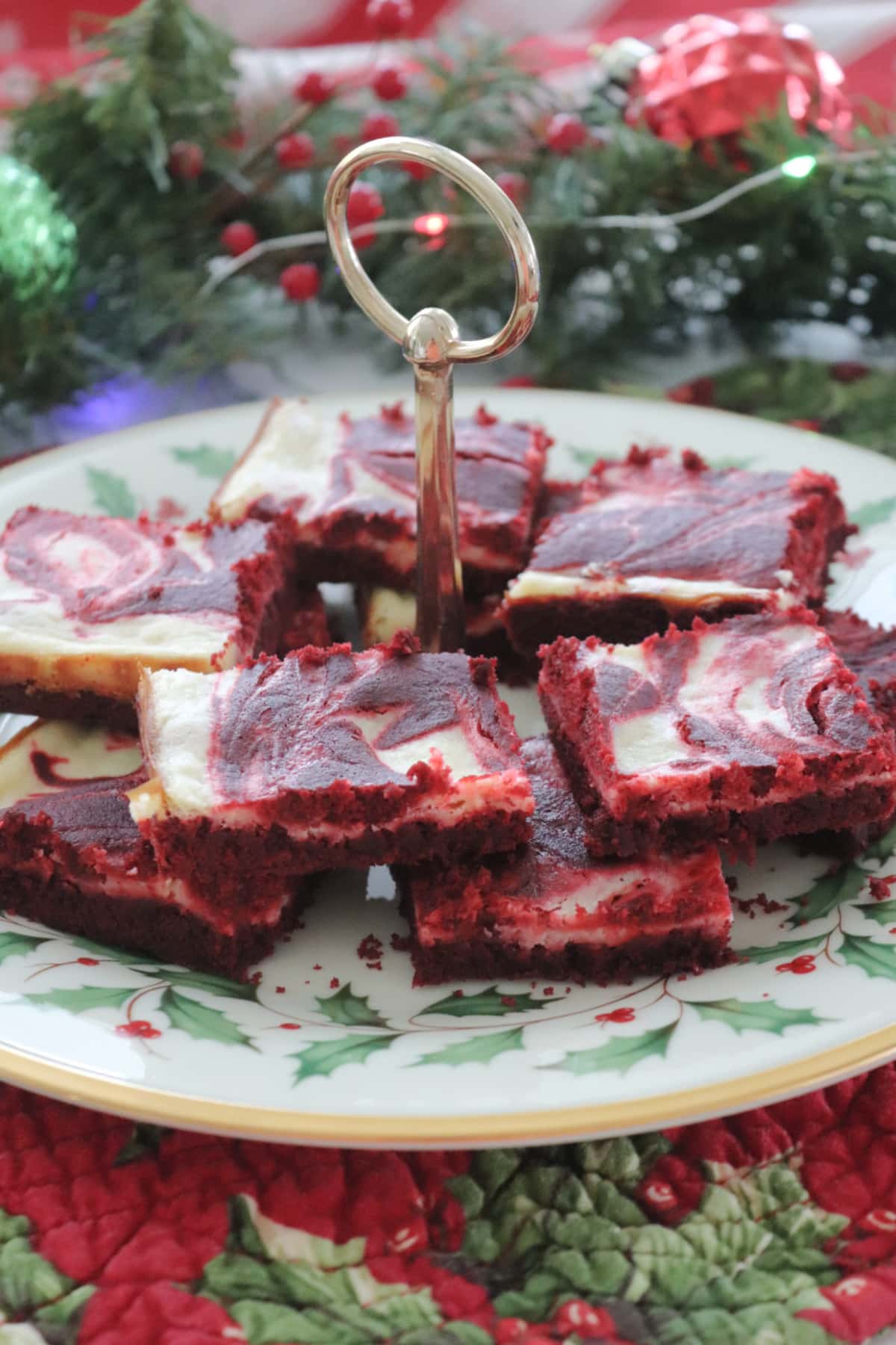 Red velvet cheesecake bars on a Christmas plate.