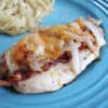 Smothered chicken on a blue plate.