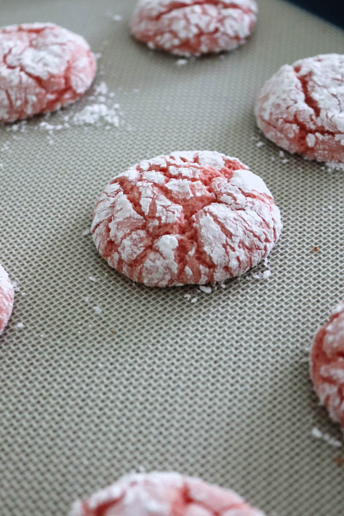 Strawberry cake mix crinkle cookies on a baking sheet.