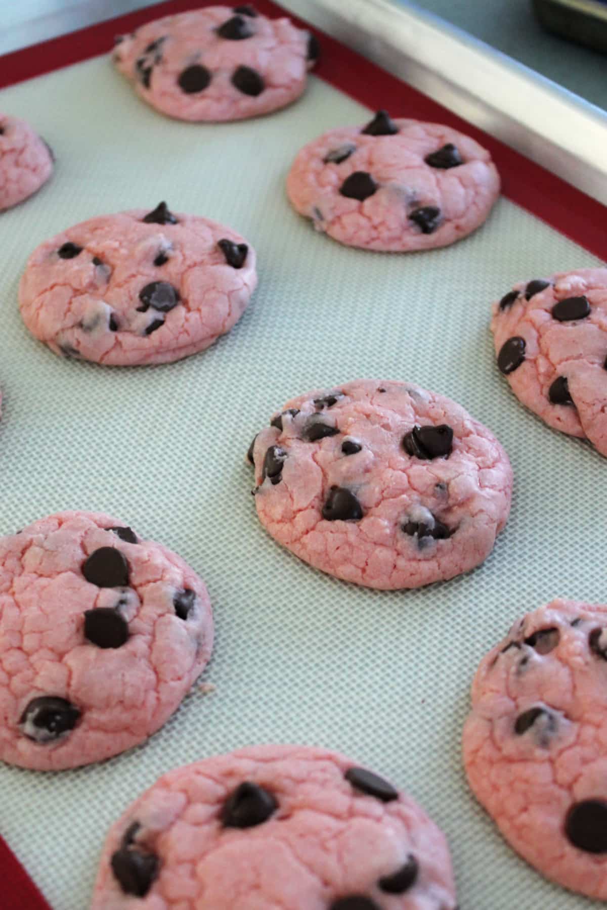 Strawberry chocolate chip cookies on a baking sheet.