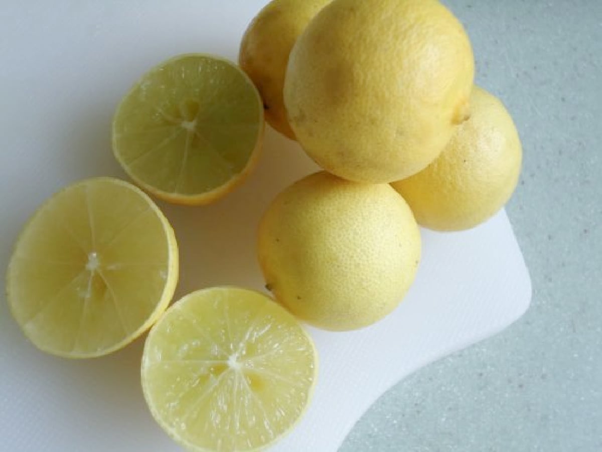 Ripe Key limes on a white cutting board.