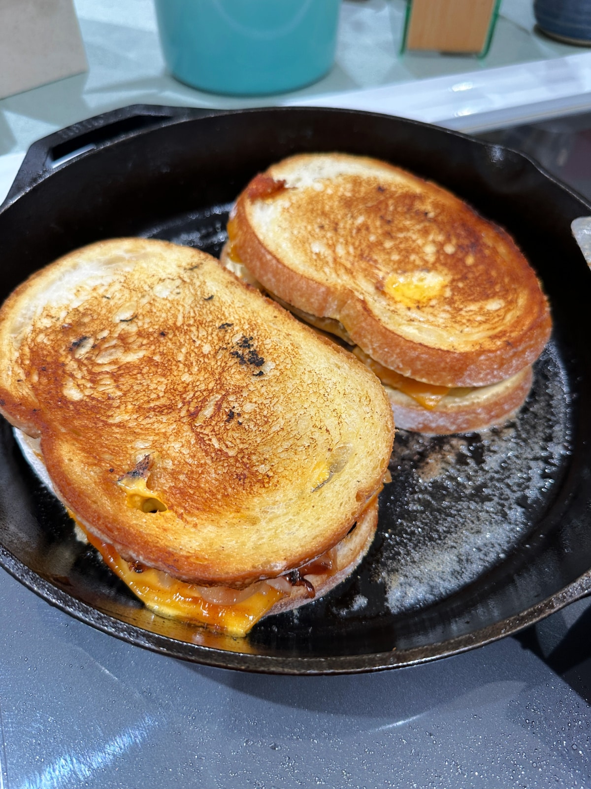 Two patty melts in a skillet.