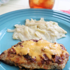 Cheesy BBQ Chicken Skillet on a blue plate with butter noodles.