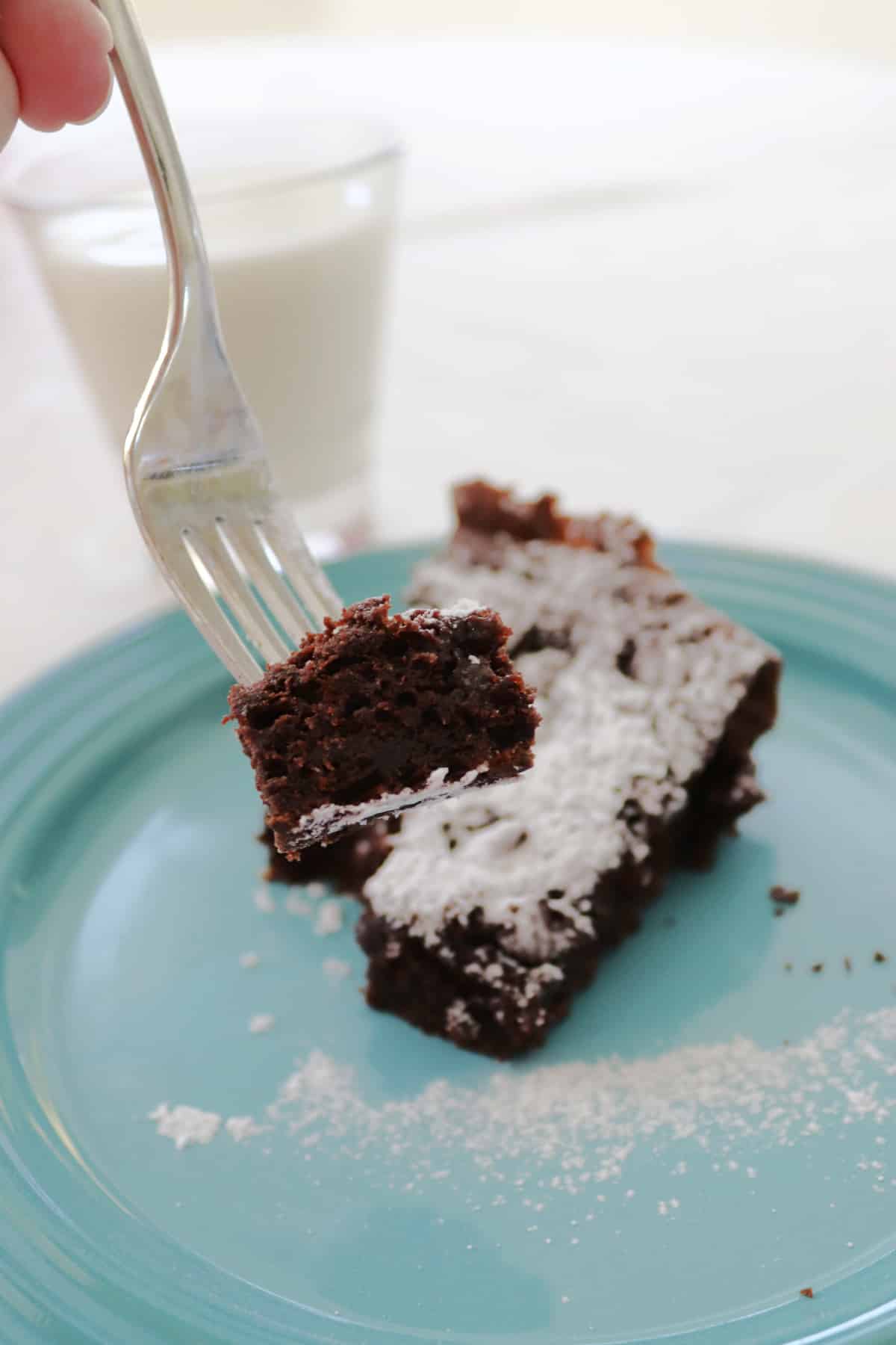 A piece of chocolate chip dump cake on a fork.
