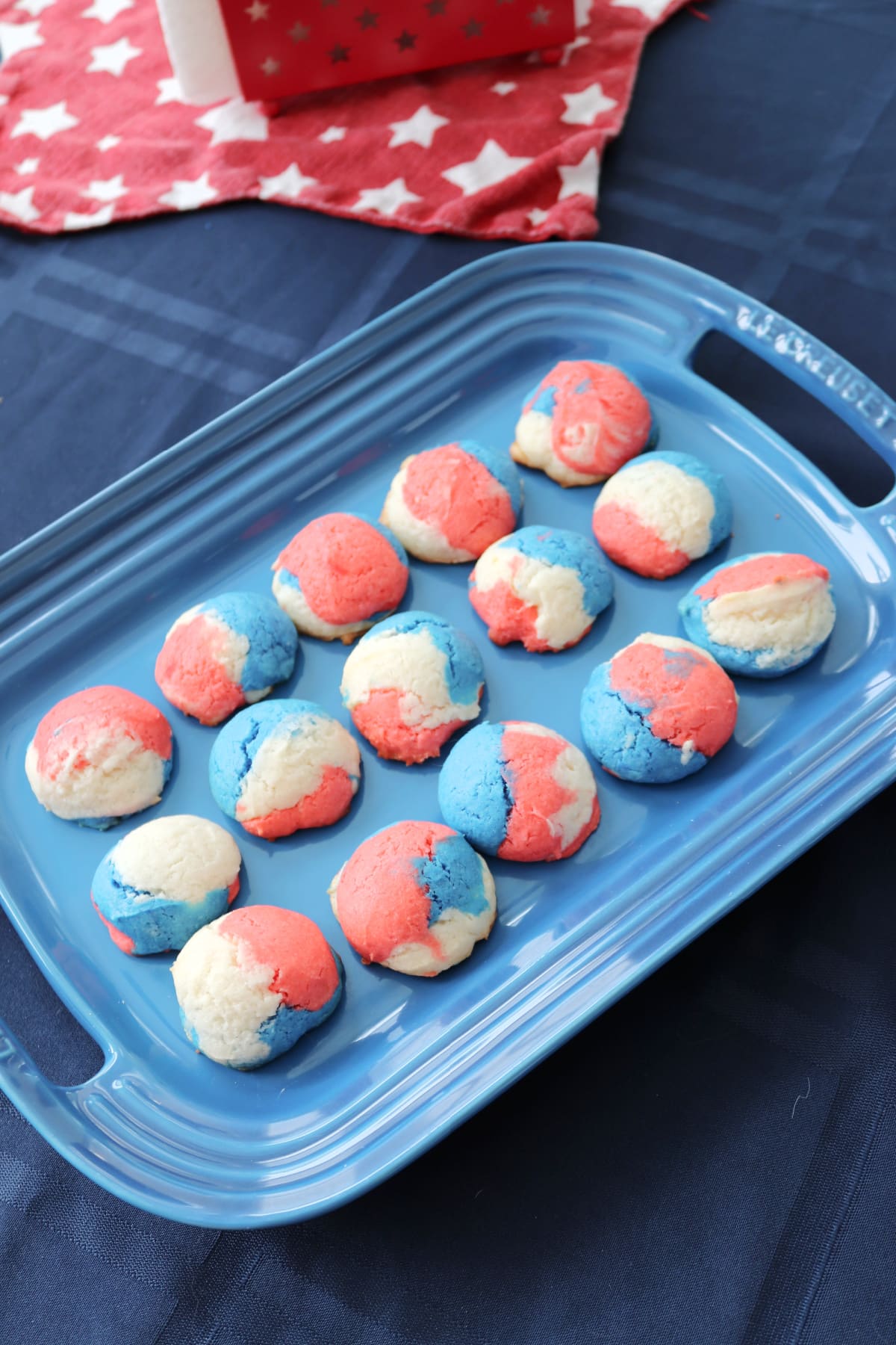 Red white and blue cookies on a blue platter.
