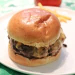 A single butter burger on a white plate.