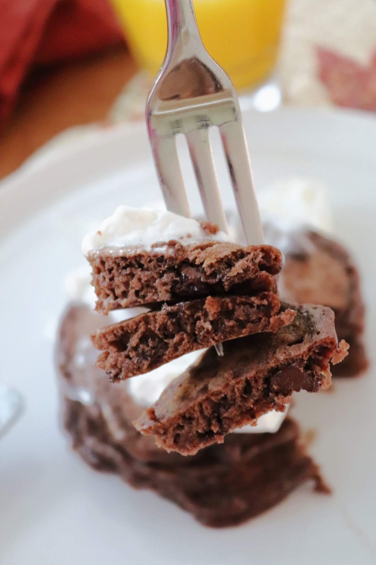 A fork with pieces of chocolate pancakes on it.