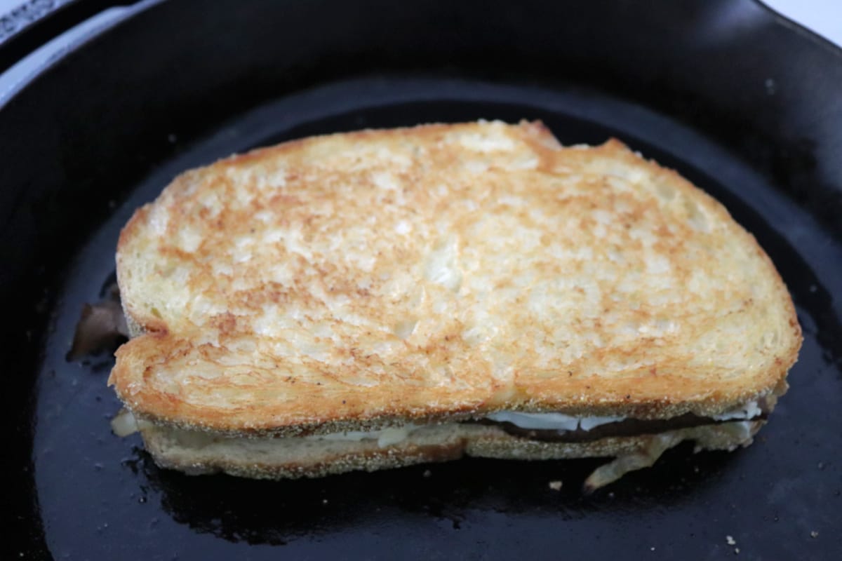 Roast beef, brie, and caramelized onions grilled cheese sandwich.